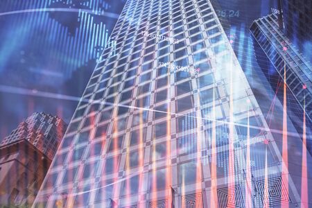 Forex chart on cityscape with tall buildings background multi exposure. Financial research concept.の写真素材