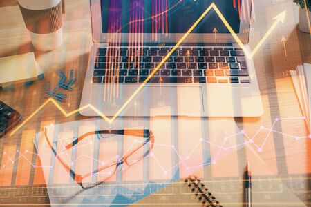 Double exposure of forex chart and work space with computer. Concept of international online trading.の写真素材