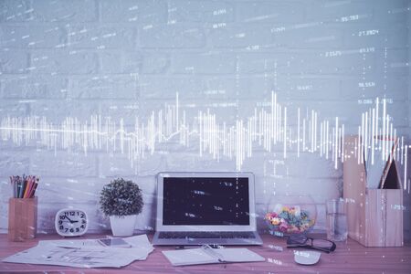 Financial market graph hologram and personal computer on background. Double exposure. Concept of forex.の写真素材