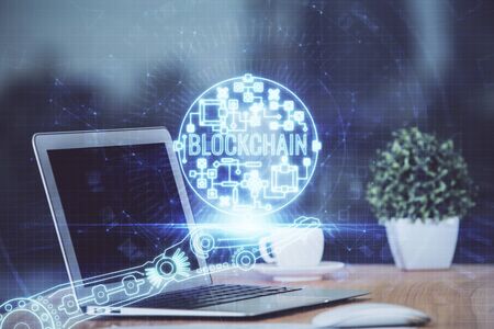 Multi exposure of blockchain theme hologram and table with computer background. Concept of bitcoin crypto currency.の写真素材
