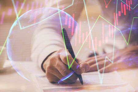 Financial trading chart multi exposure with man desktop background.の写真素材