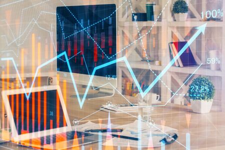 Financial chart drawing and table with computer on background. Multi exposure. Concept of international markets.の写真素材