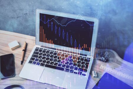 Multi exposure of graph and financial info and work space with computer background. Concept of international online trading.の写真素材