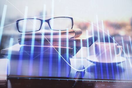 Financial graph hologram with glasses on the table background. Concept of business. Double exposure.の写真素材
