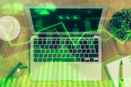 Multi exposure of graph and financial info and work space with computer background. Concept of international online trading.の写真素材