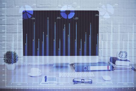 Forex graph hologram on table with computer background. Double exposure. Concept of financial markets.の写真素材