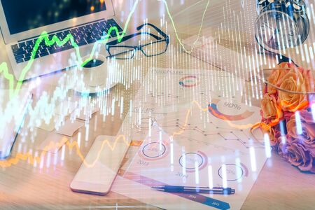 Financial market graph hologram and personal computer on background. Multi exposure. Concept of forex.の写真素材