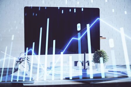 Forex graph hologram on table with computer background. Multi exposure. Concept of financial markets.の写真素材