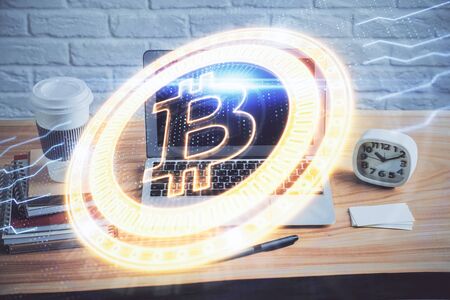 Multi exposure of blockchain theme hologram and table with computer background. Concept of bitcoin crypto currency.の写真素材