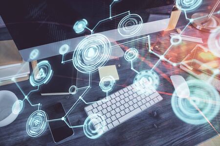 Computer on desktop with social network theme icon. Multi exposure. Concept of international connections.の写真素材