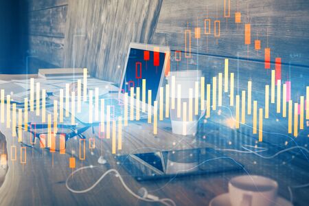 Financial chart drawing and table with computer on background. Double exposure. Concept of...