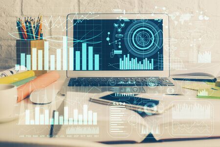 Financial chart drawing and table with computer on background. Multi exposure. Concept of...