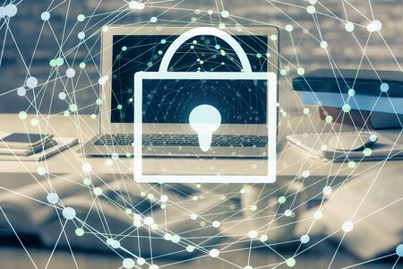 Double exposure of desktop with computer and lock icon hologram. Concept of data safety.の写真素材