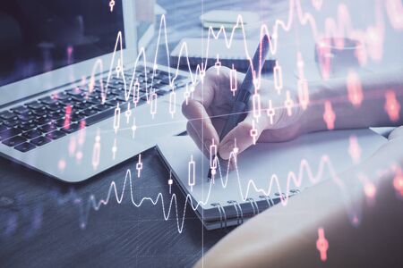 Forex chart displayed on woman's hand taking notes background. Concept of research. Multi exposureの写真素材