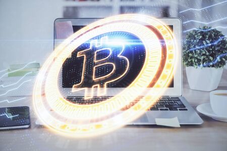 Multi exposure of blockchain theme hologram and table with computer background. Concept of bitcoin crypto currency.の写真素材