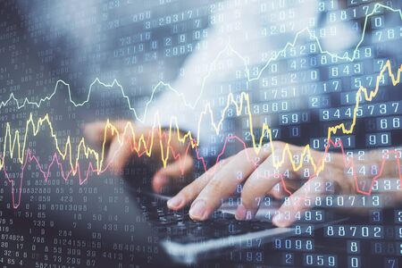 Forex graph with businessman typing on computer in office on background. Concept of analysis. Double exposure.の写真素材