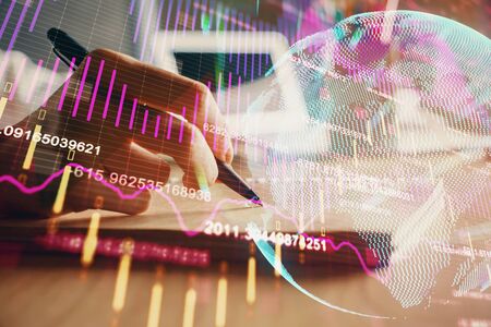 Financial charts displayed on womans hand taking notes background. Concept of research. Double exposureの写真素材