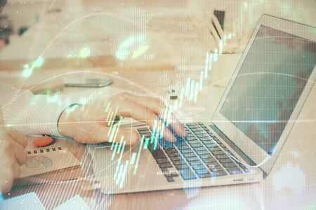 Double exposure of stock market graph with man working on laptop on background. Concept of financial analysis.の写真素材