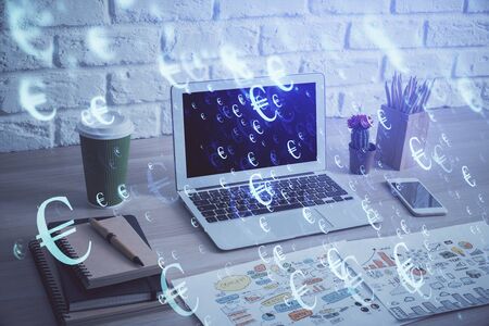 Financial chart drawing and table with computer on background. Double exposure. Concept of international markets.の写真素材
