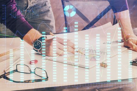 Multi exposure of man hands with stock market forex graph.の写真素材