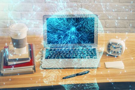 Double exposure of table with computer and brain hologram. Data innovation concept.の写真素材