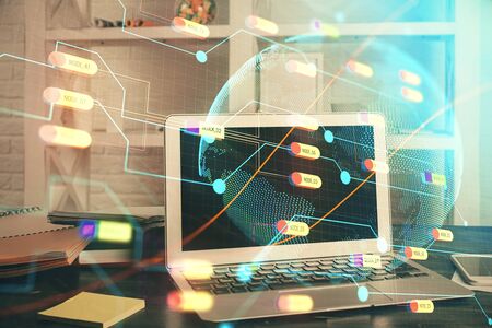 Multi exposure of table with computer and world map hologram. International data network concept.の写真素材