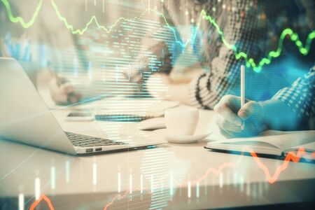 Multi exposure of forex chart with man working on computer on background. Concept of market...