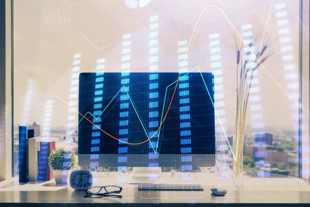 Financial market graph hologram and personal computer on background. Multi exposure. Concept of forex.の写真素材