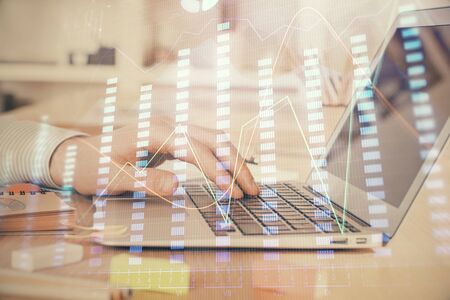 Double exposure of stock market graph with man working on laptop on background. Concept of financial analysis.の写真素材