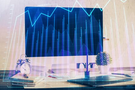 Stock market chart hologram drawn on personal computer background. Multi exposure. Concept of investment.の写真素材