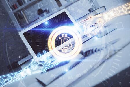 Multi exposure of blockchain theme hologram and table with computer background. Concept of bitcoin crypto currency.の写真素材
