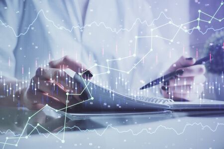 Financial chart drawn over hands taking notes background. Concept of research. Multi exposureの写真素材