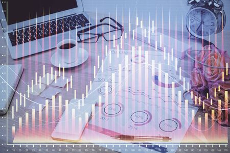 Financial chart drawing and table with computer on background. Double exposure. Concept of international markets.の写真素材