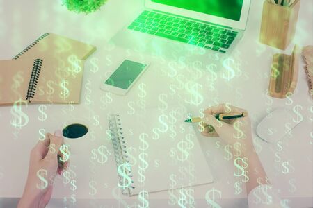 Hands writing information about stock market in notepad. Forex chart holograms in front. Concept of research. Multi exposureの写真素材