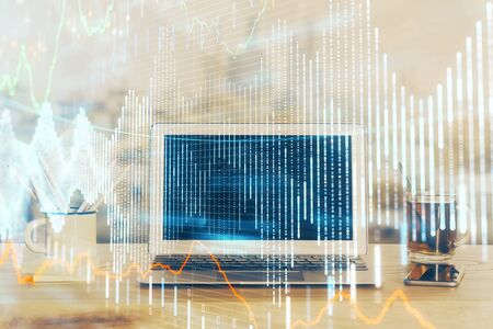Stock market graph and table with computer background. Double exposure. Concept of financial analysis.の写真素材