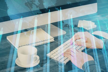 Multi exposure of graph with man typing on computer in office on background. Concept of hard work.