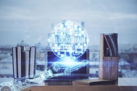 Multi exposure of blockchain theme hologram and table with computer background. Concept of bitcoin crypto currency.の写真素材