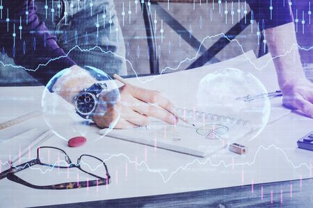 Financial trading chart double exposure with man desktop background.の写真素材