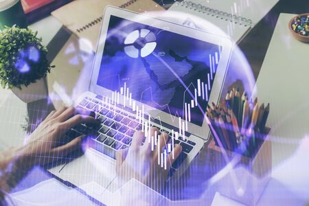 Double exposure of businessman with laptop and stock market forex chart.