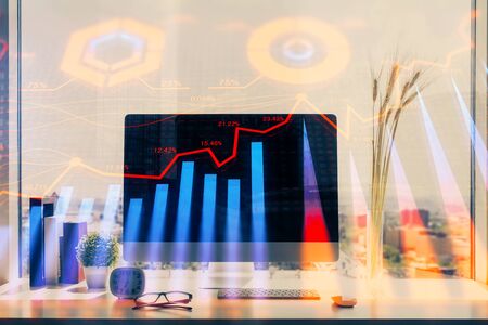 Stock market chart hologram drawn on personal computer background. Double exposure. Concept of investment.の写真素材
