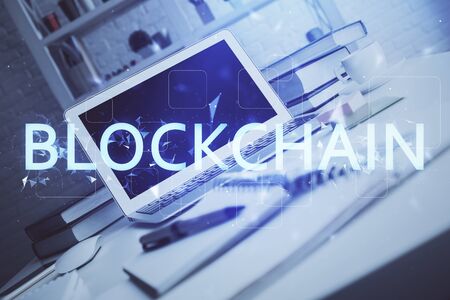 Multi exposure of blockchain theme hologram and table with computer background. Concept of bitcoin crypto currency.の写真素材
