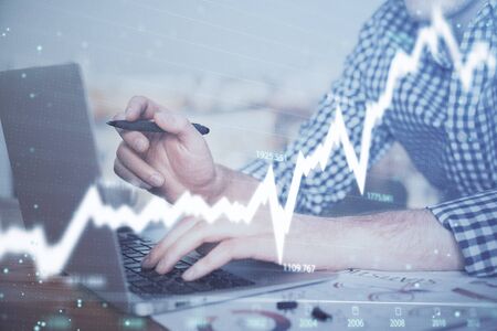 Double exposure of forex graph with man working on computer on background. Concept of market analysis.の写真素材