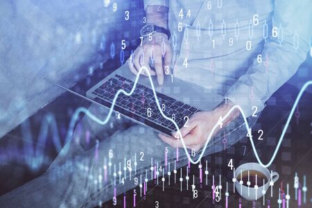 Forex graph with businessman working on computer in office on background. Concept of analysis....