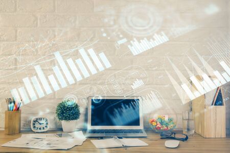 Financial market graph hologram and personal computer on background. Double exposure. Concept of forex.の写真素材
