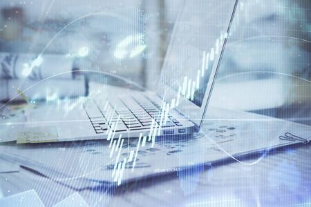 Stock market graph on background with desk and personal computer. Double exposure. Concept of...
