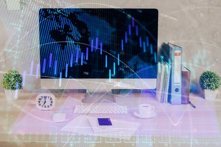 Forex graph hologram on table with computer background. Double exposure. Concept of financial markets.の写真素材