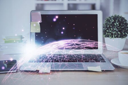 Computer on desktop with social network theme icon. Multi exposure. Concept of international connections.の写真素材