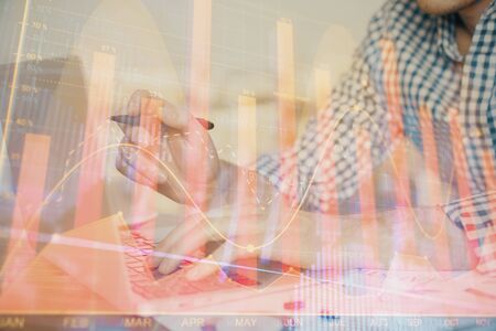 Multi exposure of forex graph with man working on computer on background. Concept of market analysis.の写真素材