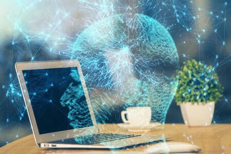 Double exposure of table with computer and brain hologram. Data innovation concept.の写真素材