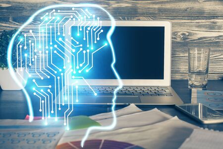 Double exposure of table with computer and brain hologram. Data innovation concept.